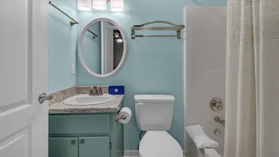 a bathroom with a toilet and a sink and a mirror at Beachside Villas 513 in Santa Rosa Beach