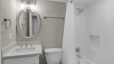 a bathroom with a sink and a toilet and a mirror at Beachcrest 402 in Santa Rosa Beach