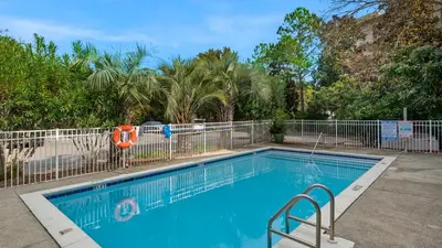 a swimming pool with a metal fence around it at Grand Isle 304 in Santa Rosa Beach