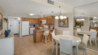 a kitchen and living room with a table and a dining room at Beachcrest 404 in Santa Rosa Beach