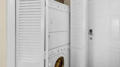 a white laundry room with a washer and dryer at Beachcrest 404 in Santa Rosa Beach