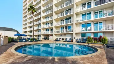 a swimming pool in front of a hotel at Beachcrest 404 in Santa Rosa Beach