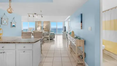 a kitchen and living room with a view of the ocean at Beachcrest 406 in Santa Rosa Beach