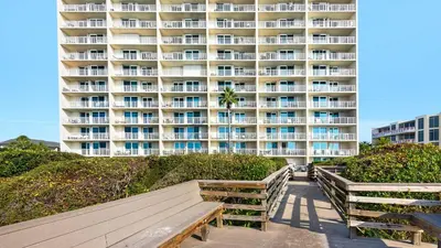 a large apartment building with benches in front of it at Beachcrest 406 in Santa Rosa Beach