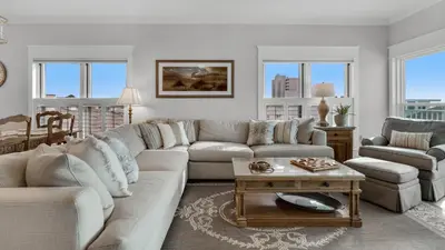 a living room with a couch and a table at Grand Playa 401 in Santa Rosa Beach
