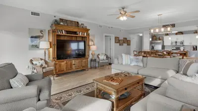 a living room with a couch and a tv at Grand Playa 401 in Santa Rosa Beach