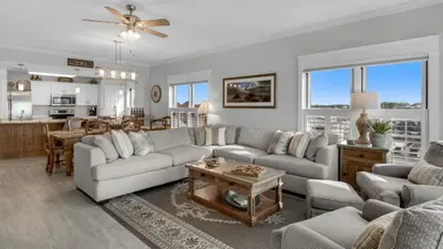 a living room with a couch and a table at Grand Playa 401 in Santa Rosa Beach