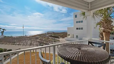 a balcony with a table and a view of the beach at Beachside Villas 621 in Santa Rosa Beach