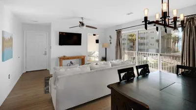 a living room with a white couch and a table at Beachside Villas 621 in Santa Rosa Beach
