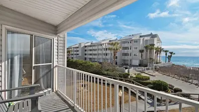 a balcony with a view of a hotel and the ocean at Beachside Villas 621 in Santa Rosa Beach