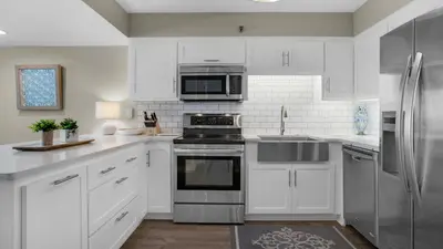 a kitchen with white cabinets and stainless steel appliances at Beachcrest 601 in Santa Rosa Beach