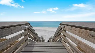 a wooden boardwalk leading to the beach at Hidden Beach 101 in Santa Rosa Beach