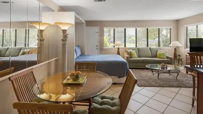 a living room with a bed and a dining room at Hidden Beach 101 in Santa Rosa Beach