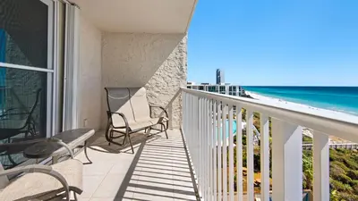 a balcony with chairs and a view of the beach at Beachcrest 603 in Santa Rosa Beach