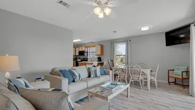 a living room with a couch and a table at Beachwood Villas 12I in Santa Rosa Beach