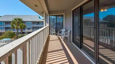 a balcony of a condo with a table and chairs at Beachwood Villas 12I in Santa Rosa Beach