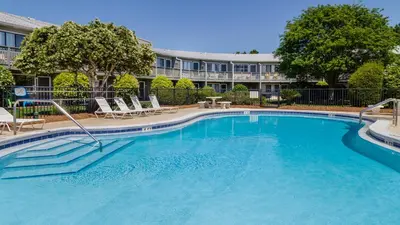 a large swimming pool with chairs and a building at Hidden Beach 228 in Santa Rosa Beach