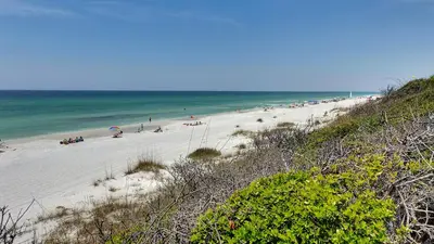 a group of people on a beach with the ocean at Hidden Beach 228 in Santa Rosa Beach