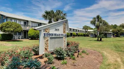 a sign in front of a building with a yard at Hidden Beach 228 in Santa Rosa Beach