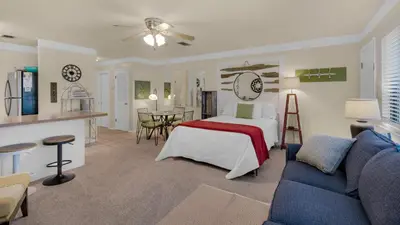 a bedroom with a bed and a living room at Hidden Beach 240 in Santa Rosa Beach