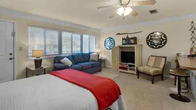 a bedroom with a bed and a couch at Hidden Beach 240 in Santa Rosa Beach