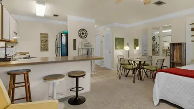 a kitchen and living room with a bed and a table at Hidden Beach 240 in Santa Rosa Beach