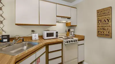 a small kitchen with a sink and a microwave at Hidden Beach 240 in Santa Rosa Beach