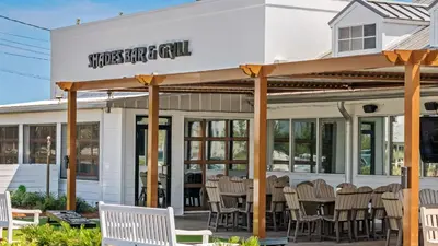 a restaurant with chairs in front of a building at Inn At Seacrest 405 in Rosemary Beach