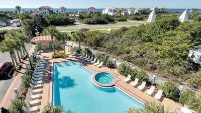 an aerial view of a swimming pool with lounge chairs and a resort at Inn At Seacrest 405 in Rosemary Beach
