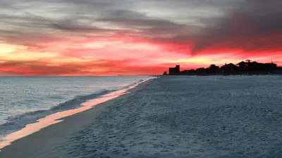 a view of a beach with a sunset at Beachcrest 806 in Santa Rosa Beach