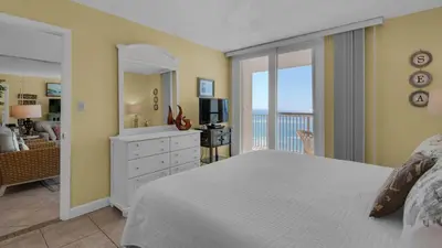 a bedroom with a bed and a view of the ocean at Beachcrest 806 in Santa Rosa Beach