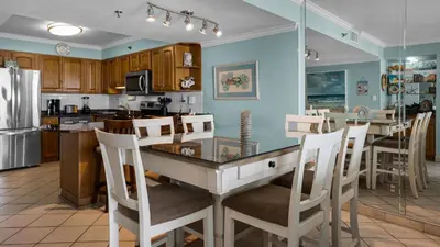 a kitchen with a table and chairs in a kitchen at Beachcrest 902 in Santa Rosa Beach
