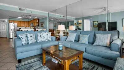 a living room with blue couches and a coffee table at Beachcrest 902 in Santa Rosa Beach
