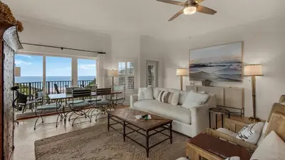 a living room with a couch and a table at Legacy 101 in Santa Rosa Beach