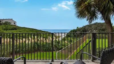 a balcony with chairs and a view of the beach at Legacy 101 in Santa Rosa Beach