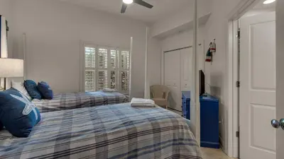 a bedroom with two beds and a window at Legacy 101 in Santa Rosa Beach
