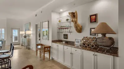 a kitchen with a counter and a dining room at Legacy 101 in Santa Rosa Beach