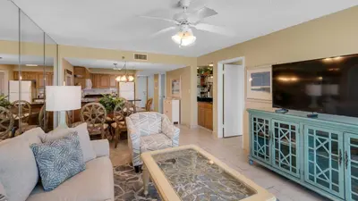 a living room with a couch and a tv at Beachcrest 903 in Santa Rosa Beach