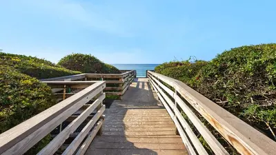 a wooden pathway leading to the ocean on a beach at Beachcrest 903 in Santa Rosa Beach
