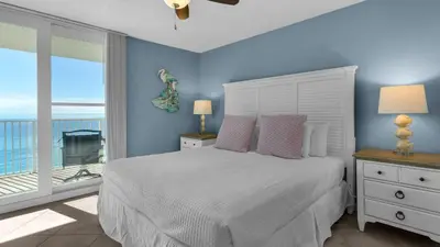 a bedroom with a bed with a view of the ocean at Beachcrest 904 in Santa Rosa Beach