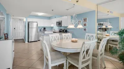 a kitchen and dining room with a table and chairs at Beachcrest 906 in Santa Rosa Beach