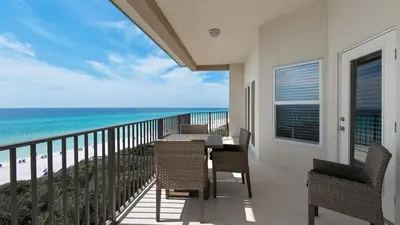a balcony with a table and chairs and the ocean at Legacy 403 in Santa Rosa Beach