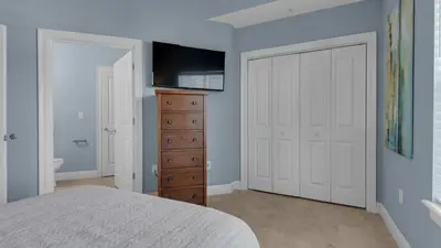 a bedroom with a bed and a dresser with a television at Legacy 403 in Santa Rosa Beach