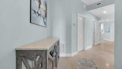 a hallway with a wooden table in a house at Legacy 403 in Santa Rosa Beach