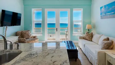 a living room with a view of the ocean at Leeward I Unit 8 in Santa Rosa Beach