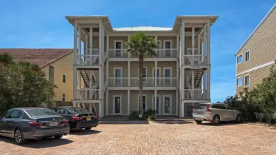 a large building with cars parked in front of it at Leeward I Unit 8 in Santa Rosa Beach