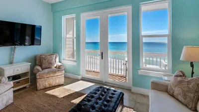 a living room with a view of the ocean at Leeward I Unit 8 in Santa Rosa Beach