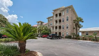 a parking lot in front of a large building at Monterey Condos C301 in Seacrest