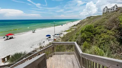 a staircase leading to a beach with a building at Monterey Condos C301 in Seacrest