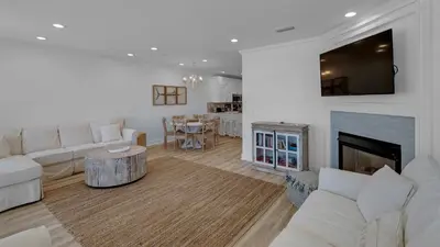 a living room with white furniture and a fireplace at Monterey Condos C301 in Seacrest